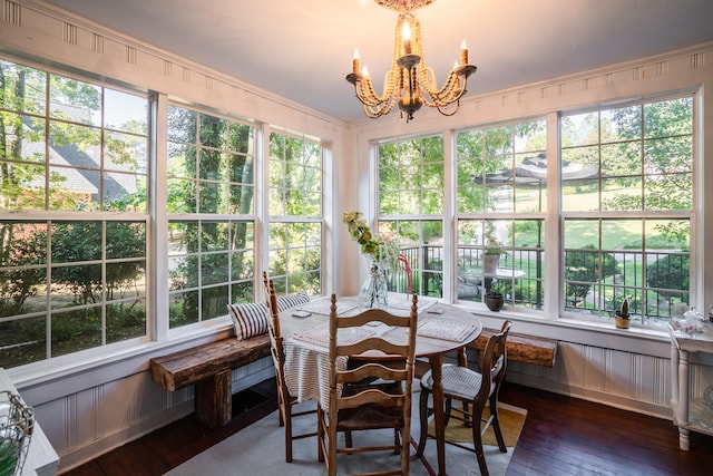 sunroom / solarium featuring a wealth of natural light and an inviting chandelier