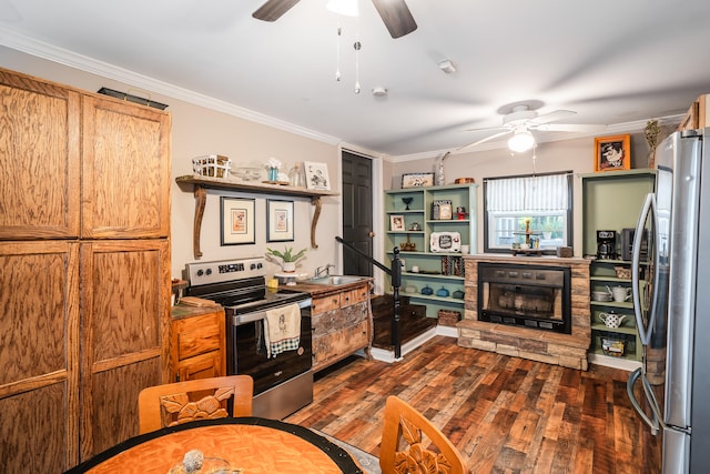 kitchen with stainless steel appliances, dark hardwood / wood-style floors, a stone fireplace, and ceiling fan