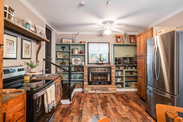 kitchen featuring a fireplace, stainless steel appliances, dark wood-type flooring, ceiling fan, and ornamental molding