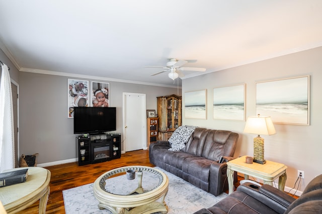 living room with crown molding, ceiling fan, and dark hardwood / wood-style floors