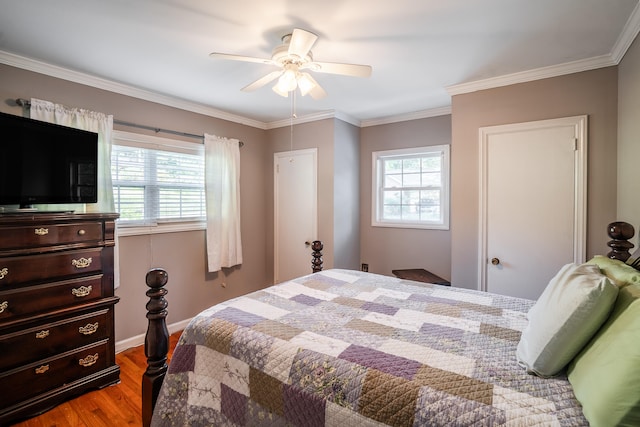 bedroom featuring ceiling fan, hardwood / wood-style flooring, and crown molding