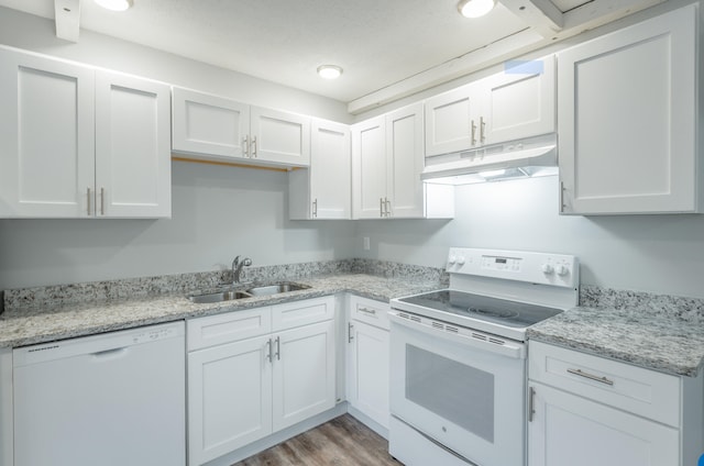 kitchen with white cabinetry, white appliances, light hardwood / wood-style flooring, and sink