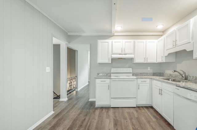 kitchen featuring hardwood / wood-style floors, white appliances, light stone counters, and white cabinetry