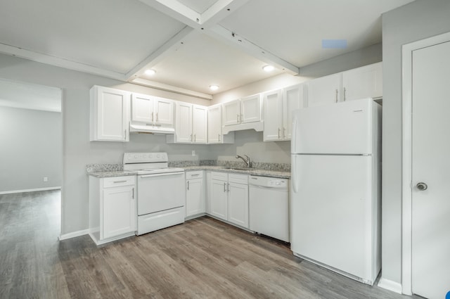 kitchen featuring white cabinets, white appliances, light stone counters, light hardwood / wood-style floors, and sink