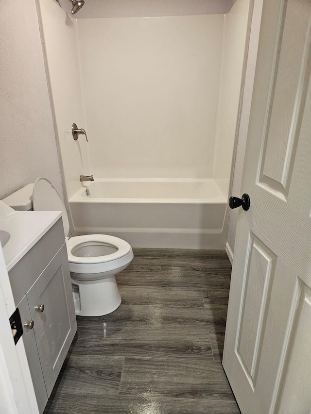 full bathroom featuring vanity, bathtub / shower combination, and toilet