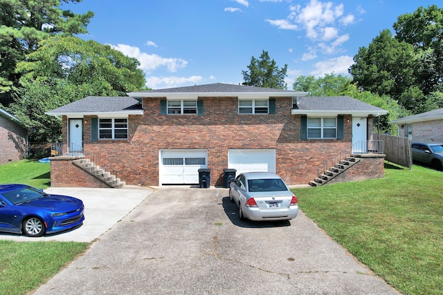 tri-level home featuring a garage and a front lawn