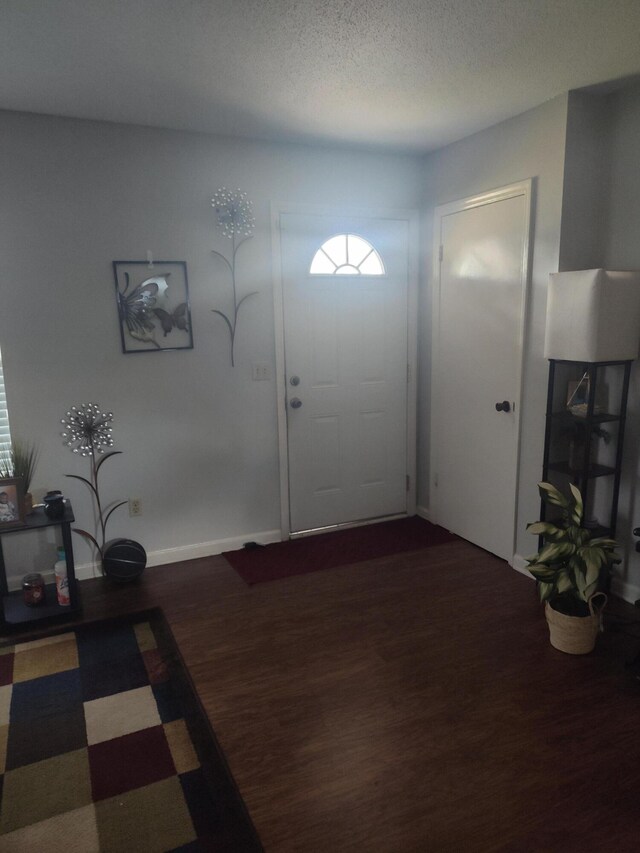 entrance foyer with wood-type flooring and a textured ceiling