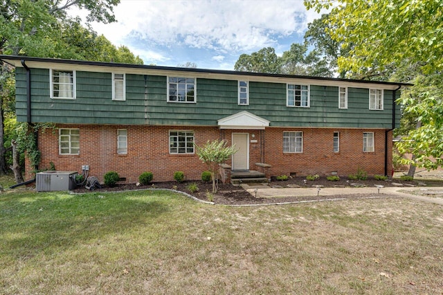 view of front of home with central air condition unit and a front yard