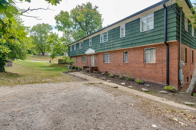 rear view of property featuring a lawn