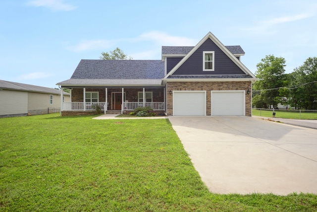 view of front of property with a front yard, a porch, and a garage