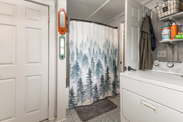 bathroom with shower / bathtub combination with curtain, vanity, and washer / clothes dryer