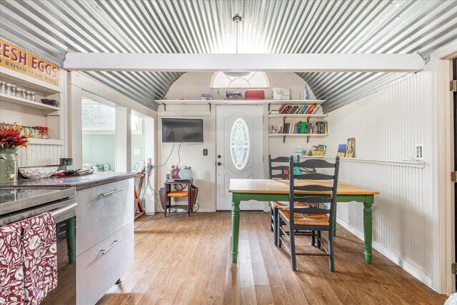 kitchen with stainless steel range and light hardwood / wood-style floors