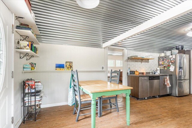 dining space with hardwood / wood-style floors