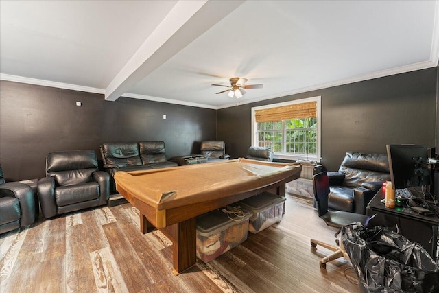 rec room featuring ceiling fan, ornamental molding, beam ceiling, and hardwood / wood-style floors