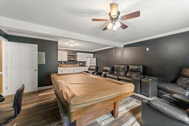 game room with ceiling fan, beamed ceiling, dark hardwood / wood-style floors, and crown molding