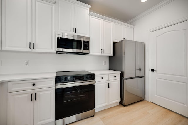 kitchen featuring stainless steel appliances, white cabinetry, and light hardwood / wood-style floors