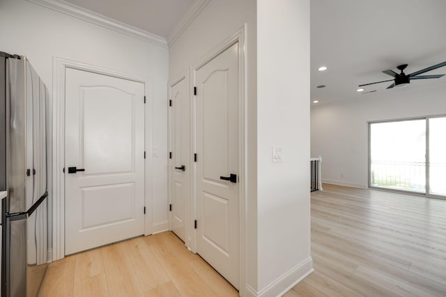 hall with crown molding and light wood-type flooring