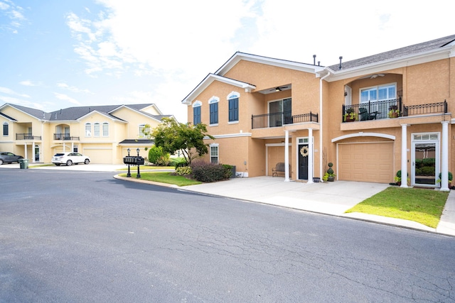 townhome / multi-family property featuring a balcony and a garage