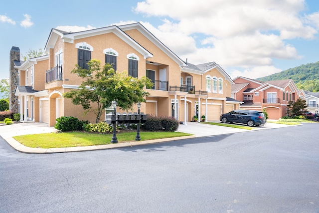 multi unit property featuring a balcony and a garage