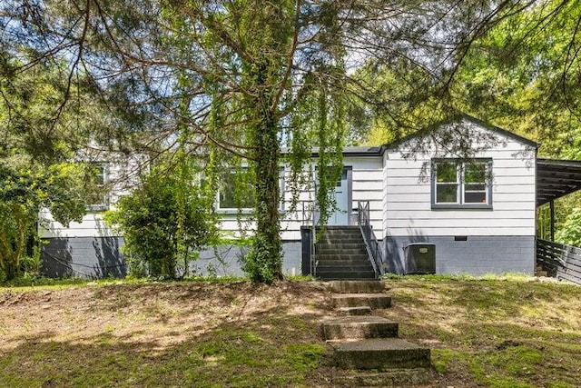 rear view of house with central AC unit