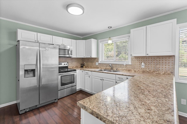 kitchen with white cabinetry, backsplash, dark hardwood / wood-style flooring, pendant lighting, and stainless steel appliances