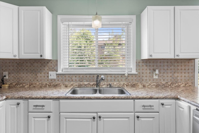 kitchen featuring white cabinetry, hanging light fixtures, and sink