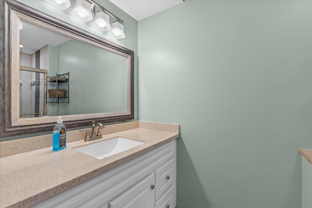 bathroom with vanity and a shower with door