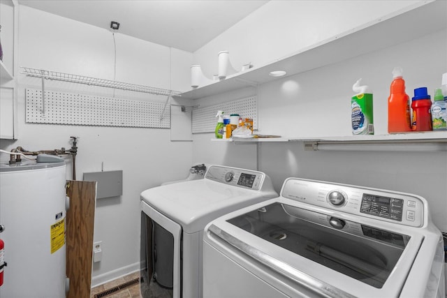 washroom with water heater and washer and dryer