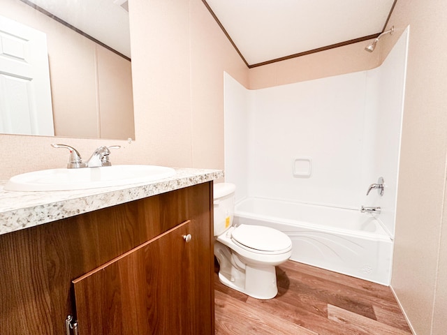 full bathroom with vanity, shower / washtub combination, crown molding, toilet, and wood-type flooring