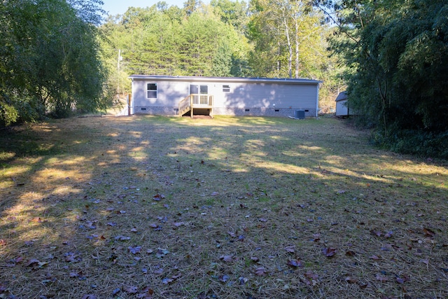 exterior space featuring central air condition unit and a yard