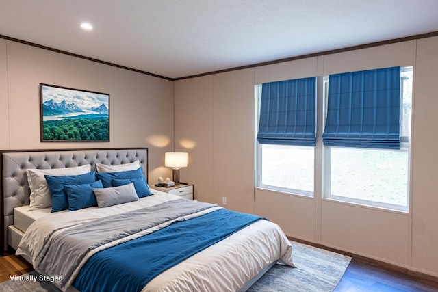 bedroom featuring crown molding and dark wood-type flooring