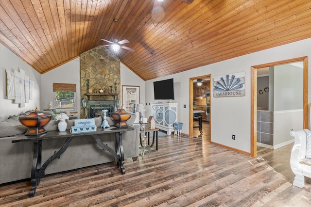 living room with hardwood / wood-style floors, a stone fireplace, wood ceiling, lofted ceiling, and ceiling fan