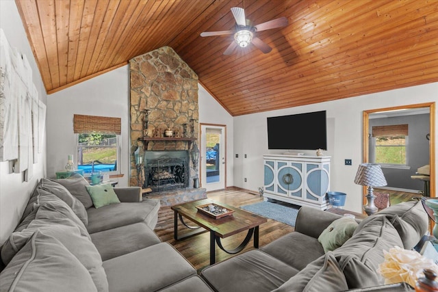 living room with high vaulted ceiling, hardwood / wood-style floors, ceiling fan, a stone fireplace, and wooden ceiling