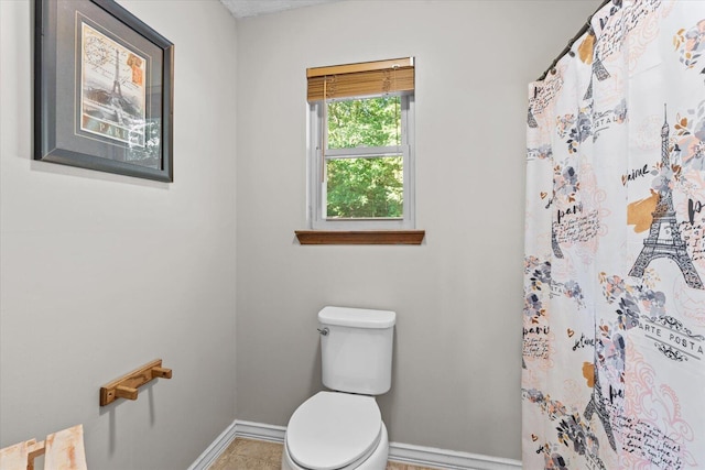 bathroom featuring toilet and walk in shower