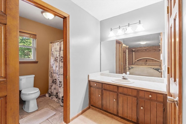 bathroom with vanity, toilet, and tile patterned flooring