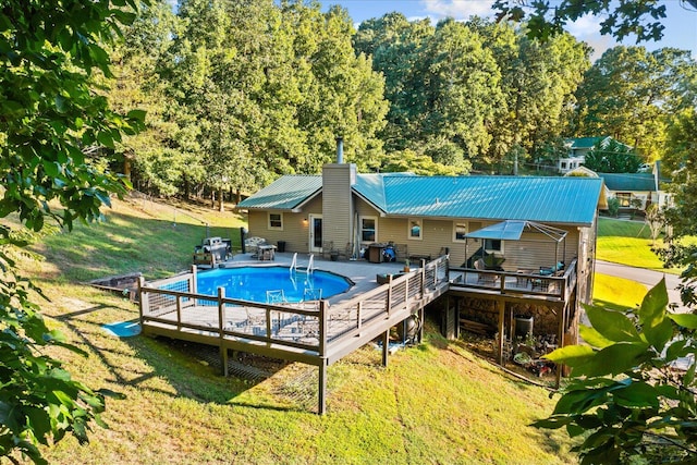 view of pool featuring a deck and a lawn