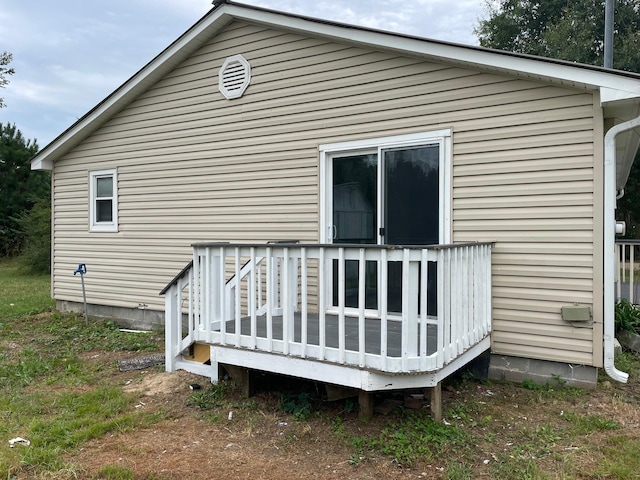 back of house featuring a wooden deck