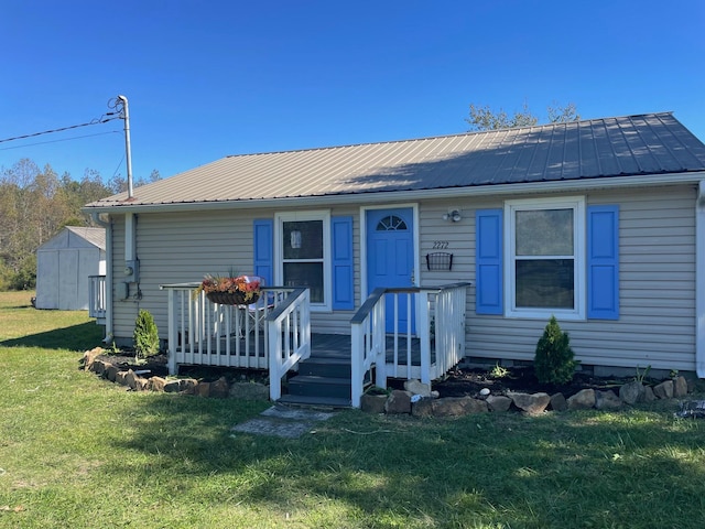 view of front of property with a shed and a front yard