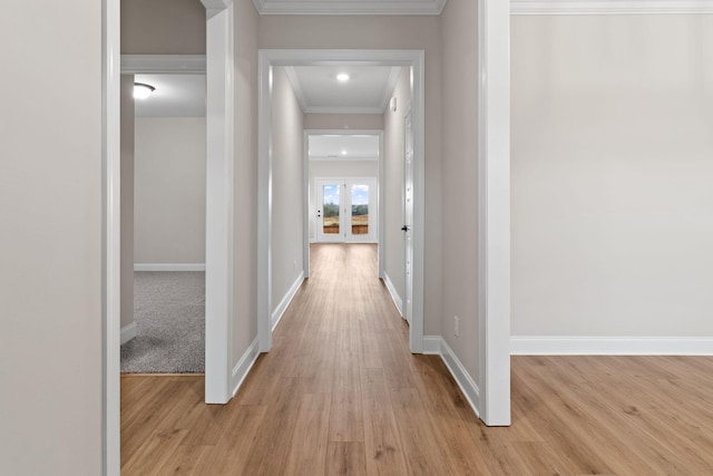 hall featuring ornamental molding and light hardwood / wood-style floors