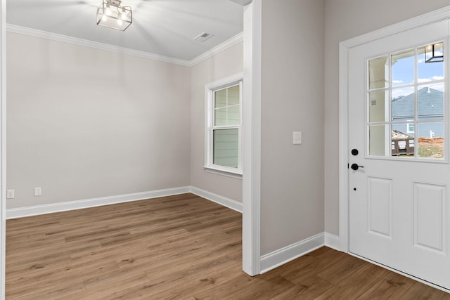 entryway featuring wood-type flooring and ornamental molding