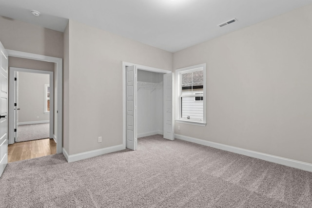 unfurnished bedroom featuring a closet and carpet