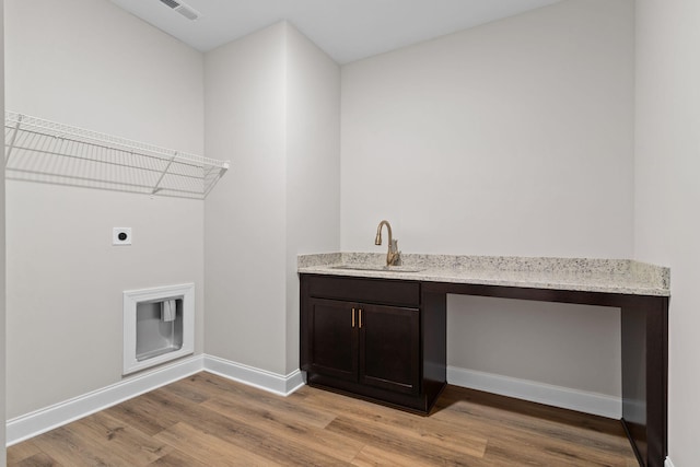 laundry room featuring cabinets, sink, light hardwood / wood-style flooring, and hookup for an electric dryer