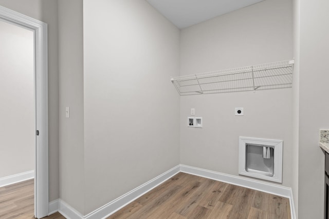 clothes washing area featuring hardwood / wood-style flooring, hookup for a washing machine, and electric dryer hookup