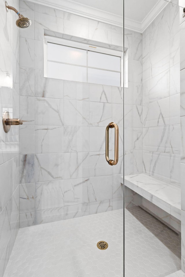 bathroom featuring crown molding and a shower with door