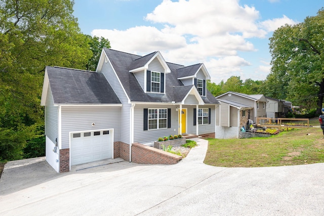 cape cod house with a garage and a front yard