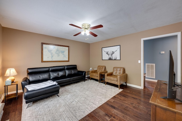 living room featuring dark hardwood / wood-style flooring and ceiling fan