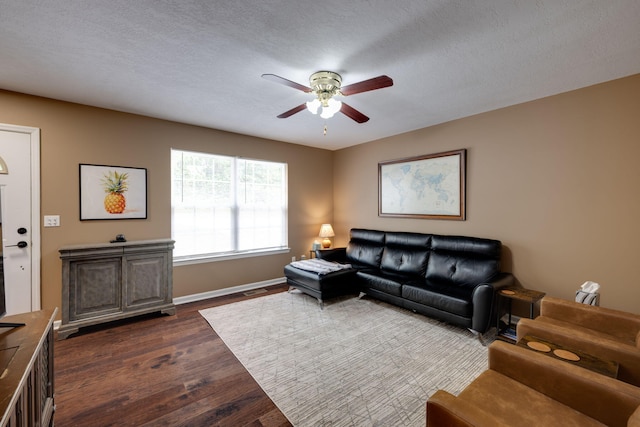 living room featuring a textured ceiling, ceiling fan, and dark hardwood / wood-style floors