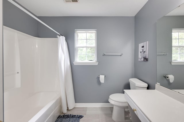 full bathroom featuring shower / bath combo, toilet, and vanity