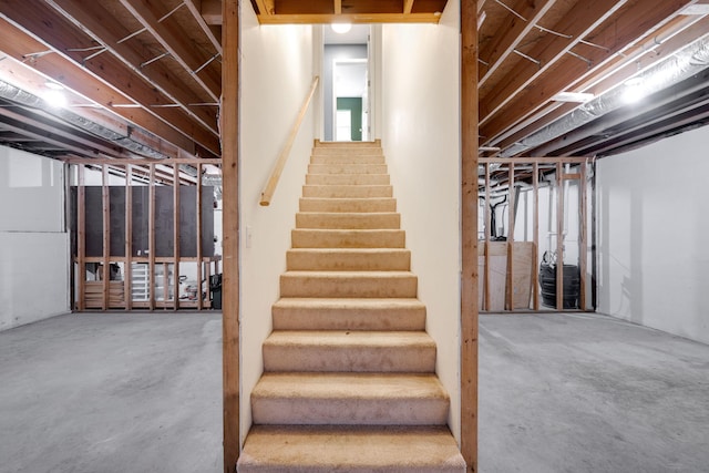 stairway featuring concrete floors