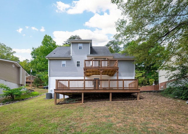 rear view of house with a yard, a deck, and cooling unit